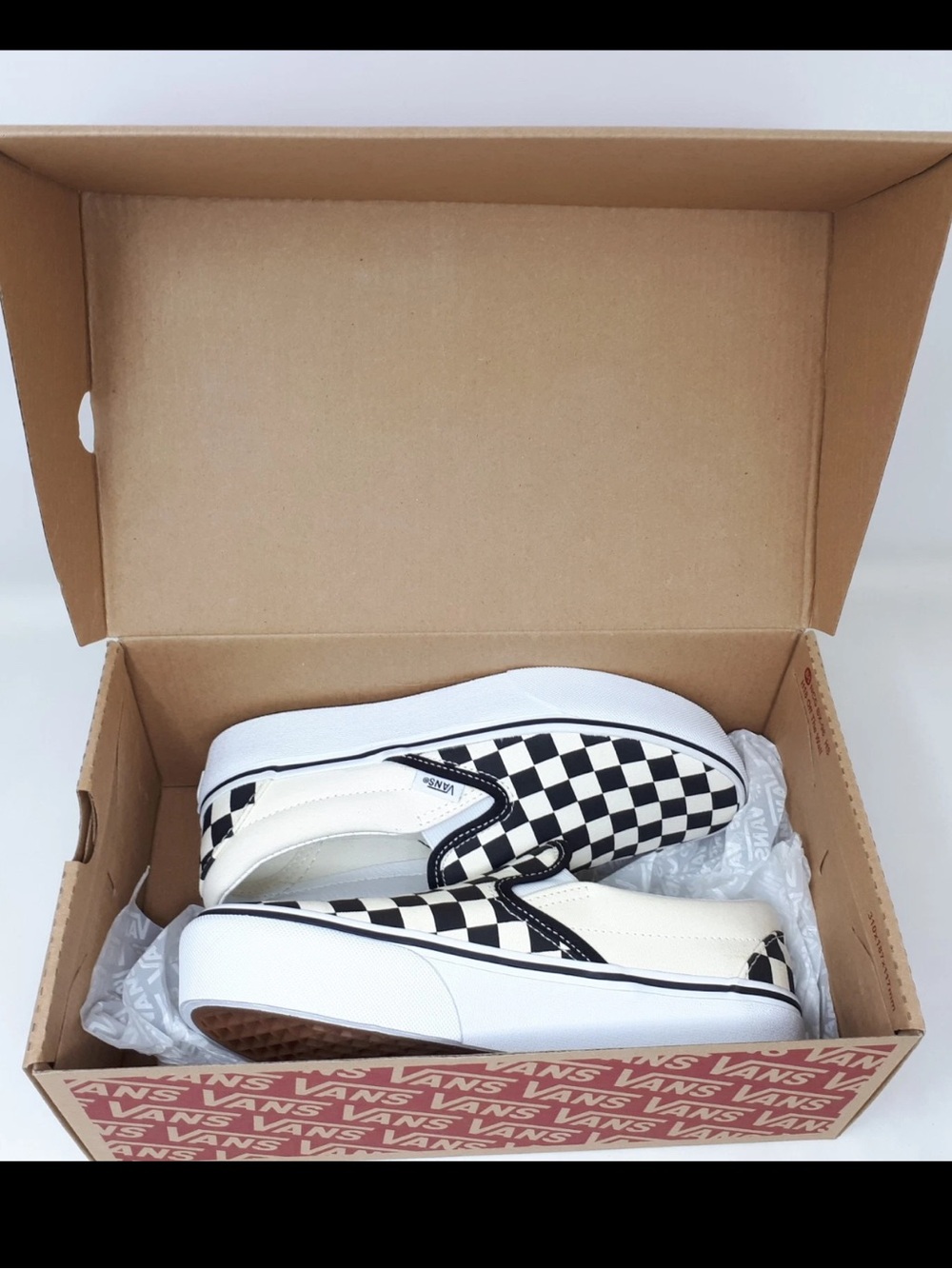Vans Checkerboard Slip-On Sneakers in Black and White